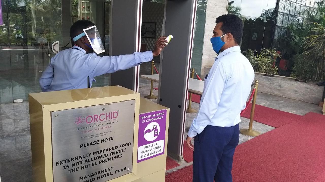 The Orchid Hotel Hinjewadi Pune Bagian luar foto Temperature check at the entrance of a hotel in India